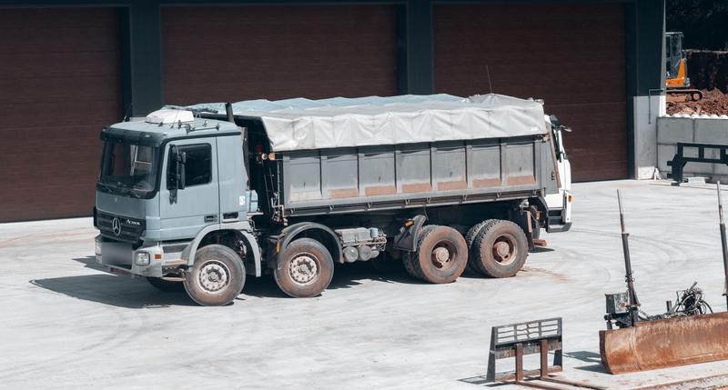 Eight-wheel tipper lorry parked on a construction site